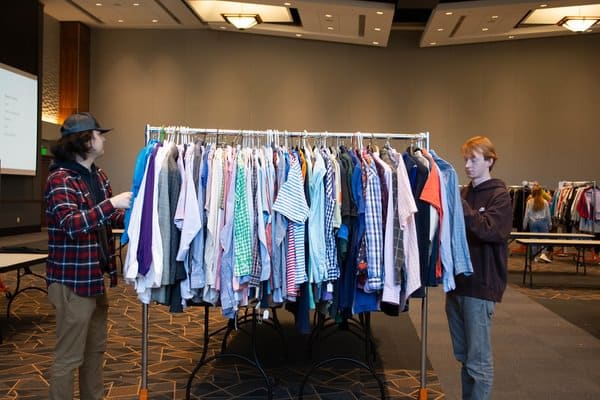 Students look through a clothing rack.