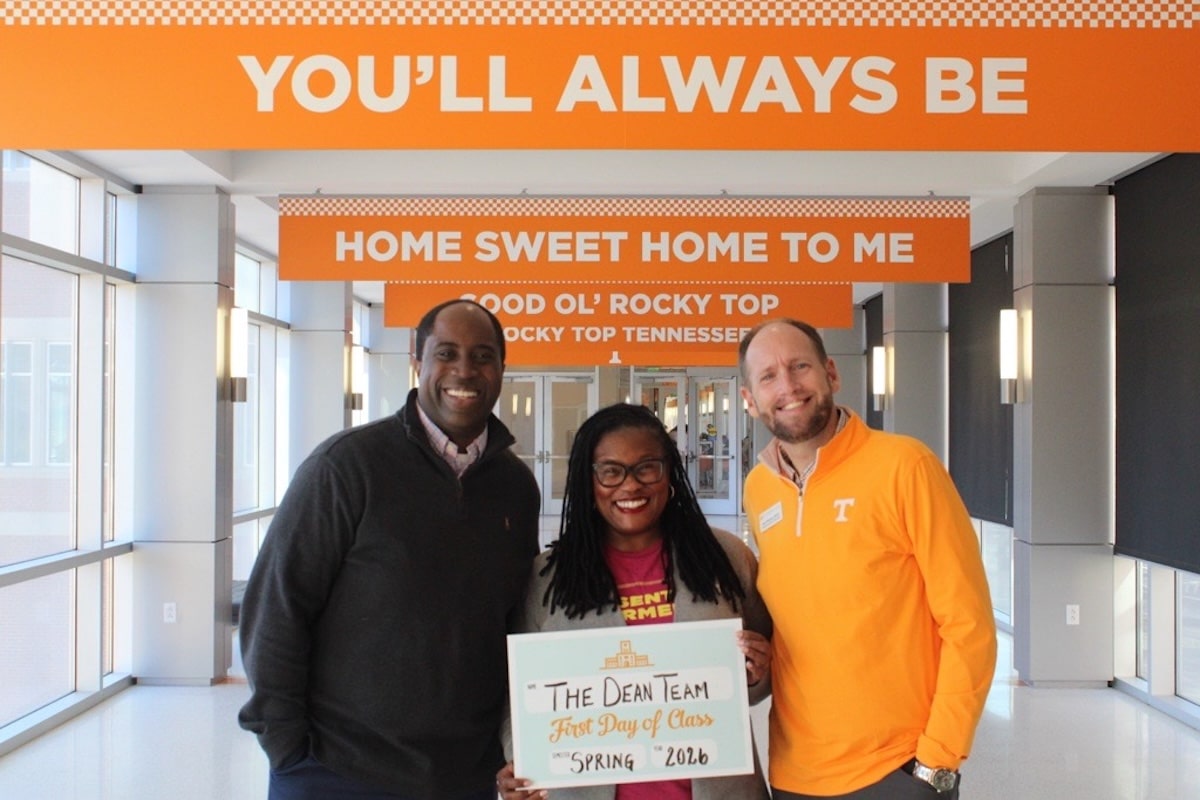 Members of the Dean Team staff smiling and holding a Spring 2026 first day of class sign.