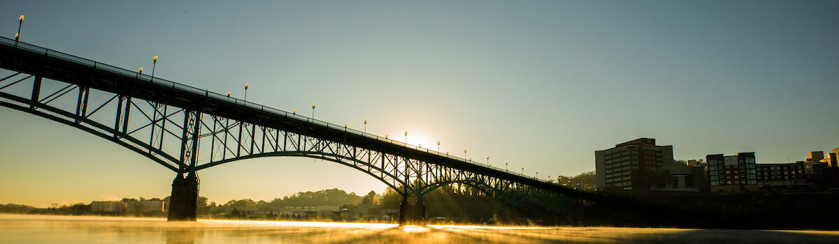 Sunrise over the Tennessee River. The sun is rising over the bridge that connects downtown Knoxville to South Knoxville.