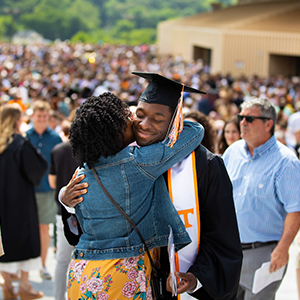 A mother and son embracing each other outside of Thompson Bowling Arena after a commencement ceremony in May.