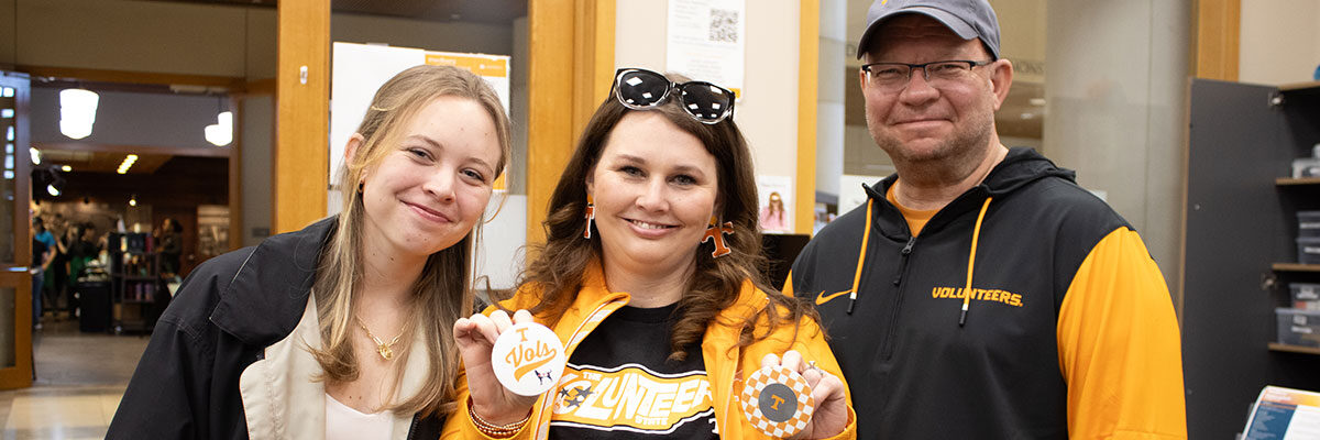 A mother and father with their daughter during Spring Family Reunion in the John C. Hodges Library.