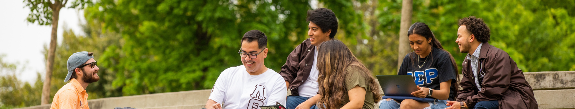 Students sitting and talking on campus plaza.