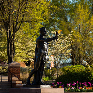 An image of the Torchbearer statue located in Circle Park. The torch is burning.