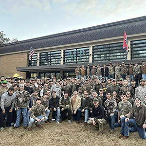 Members of Alpha Gamma Rho all dressed in camouflage outside of their fraternity house in Fraternity Park at the University of Tennessee, Knoxville.