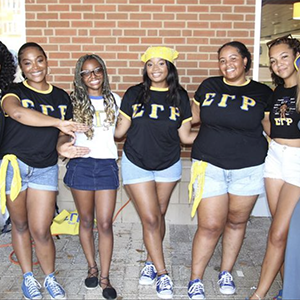 Local members of Sigma Gamma Rho Sorority, Inc. outside of the Student Union. They are all wearing their sorority's apparel.