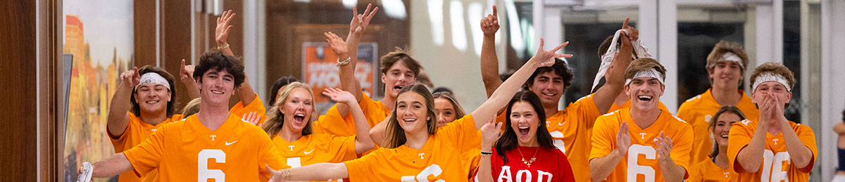 Various members of a sorority and fraternity getting ready to perform for Smokey's Howl, which is a Homecoming Tradition. The people pictured are looking at the camera with excitement.