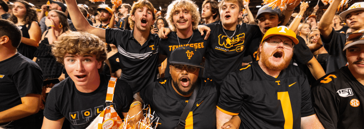Students cheer in Neyland Stadium during football game.