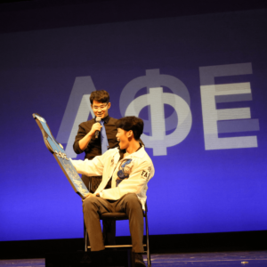 Member of Lambda Phi Epsilon on stage at national convention.