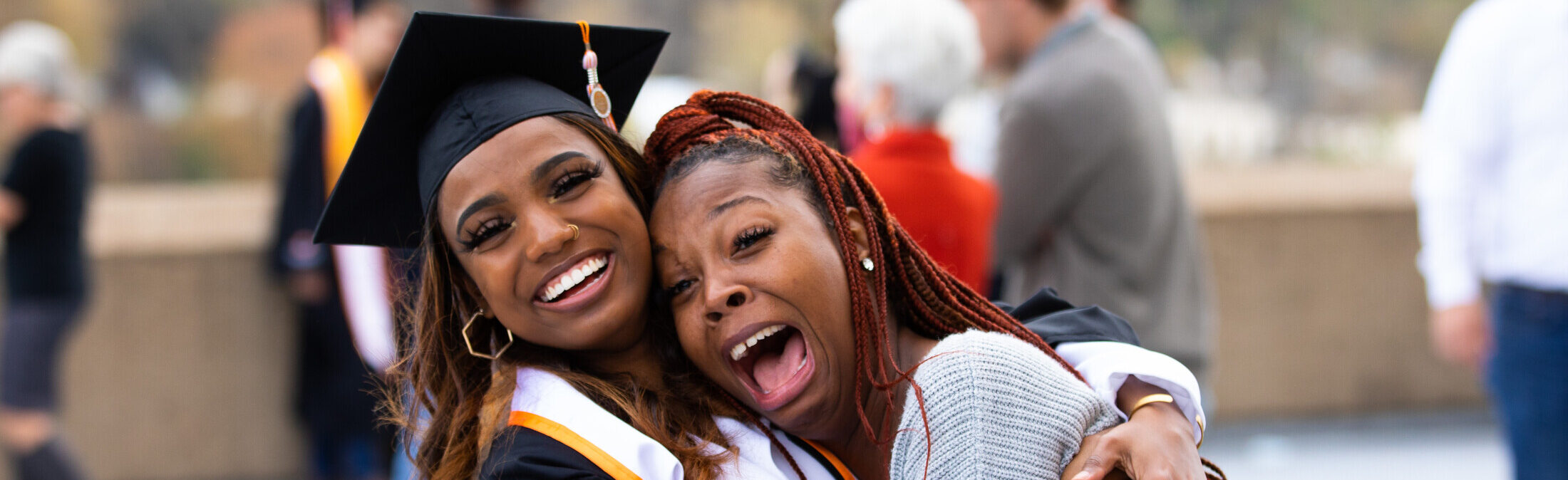 A graduate celebrates with family after the 2020 commencement ceremony for Haslam College of Business graduates in Thompson-Boling Assembly Center and Arena on November 22, 2020. Photo by Steven Bridges/University of Tennessee