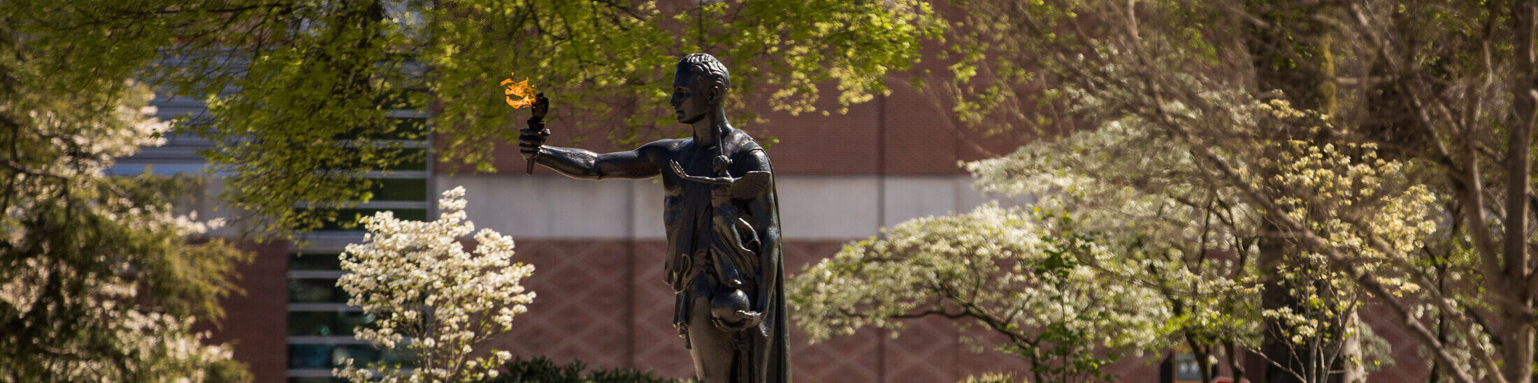 The Torchbearer Statue stands tall as spring flowers bloom in Circle Park on April 10, 2019. Photo by Steven Bridges