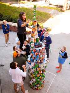 Students stack canned food items into a tower during the Tower of Cans competition