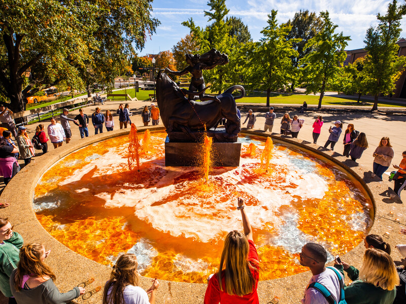 Students participate in the a homecoming tradition by the orange dyeing of the Europa and the Bull Fountain at the Humanities Plaza.