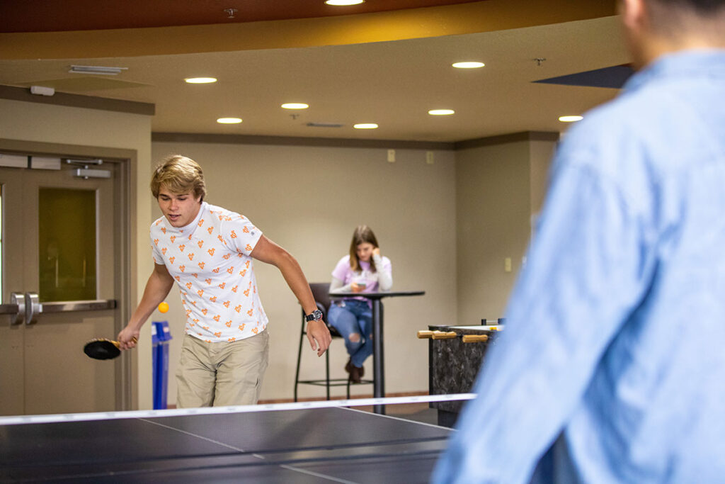 Students playing ping pong in Volunteer Hall