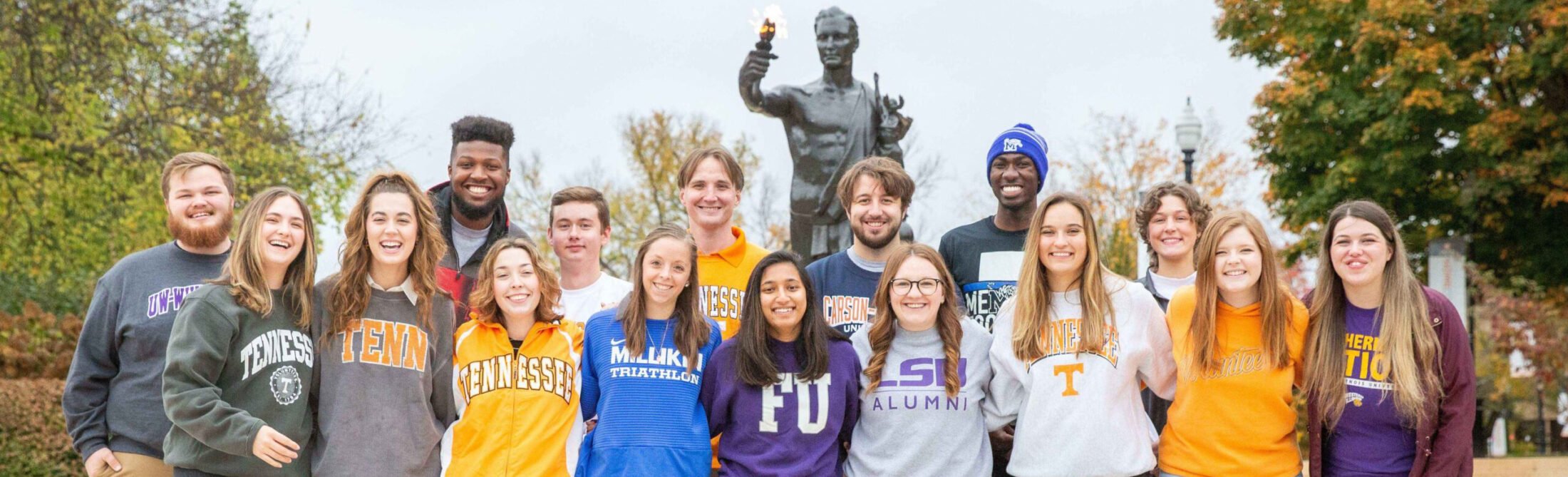 A group of hall directors where t-shirts of where they went to college