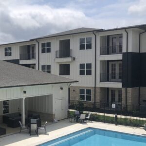 An exterior of the clubhouse and pool at Lakemoor Station