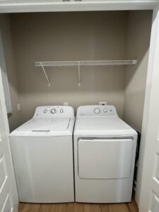 A washer and dryer placed in a closet