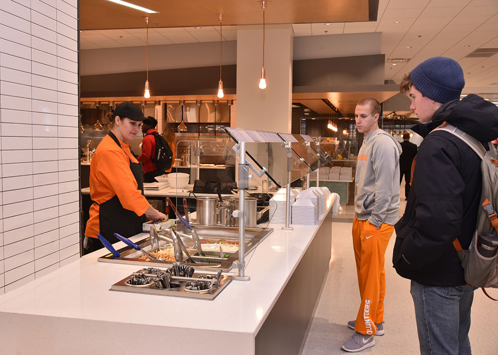 Students lining up to get food in the dining hall at Stokely Hall