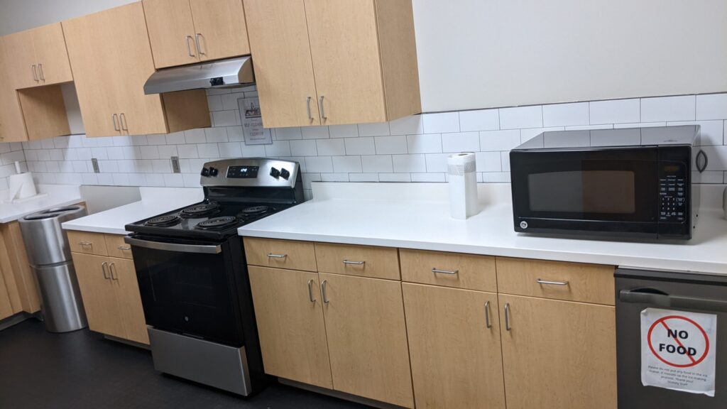 The kitchen in Stokely with neutral cabinets, a microwave on the counter and a stove