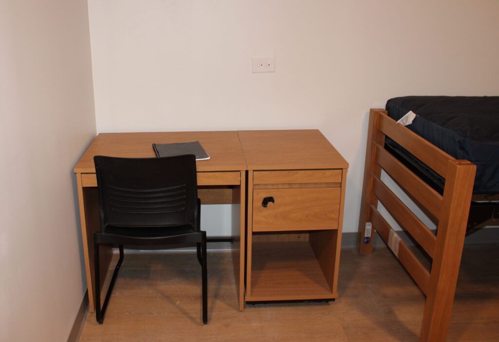 A small wooden desk with a desk chair