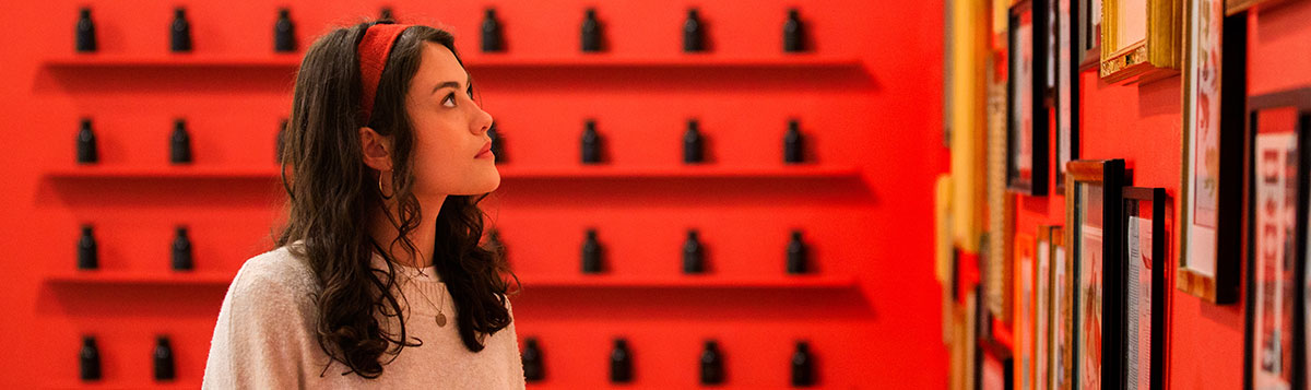 A architecture student looking up at an art installation.