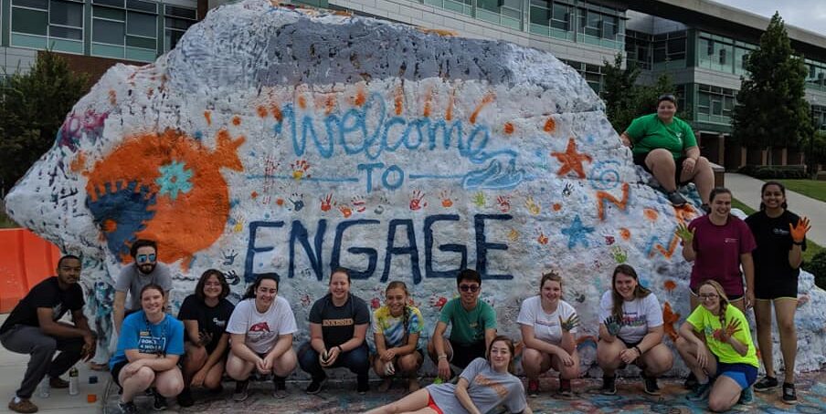 Group of students in front of the Rock with a message that says welcome to Engage.