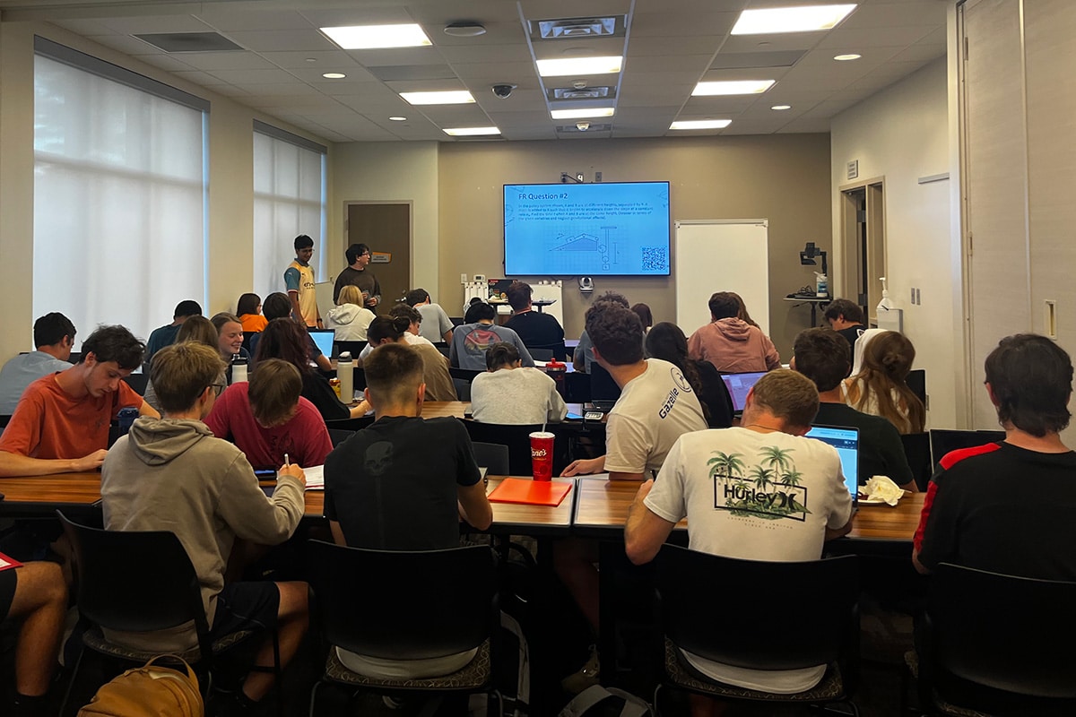 Students involved in Engage LLC listen to an exam review presentation