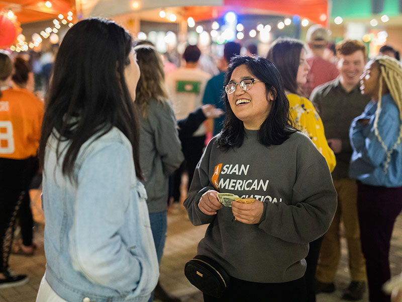 Students laugh together at the 865 Night Market hosted by AAA