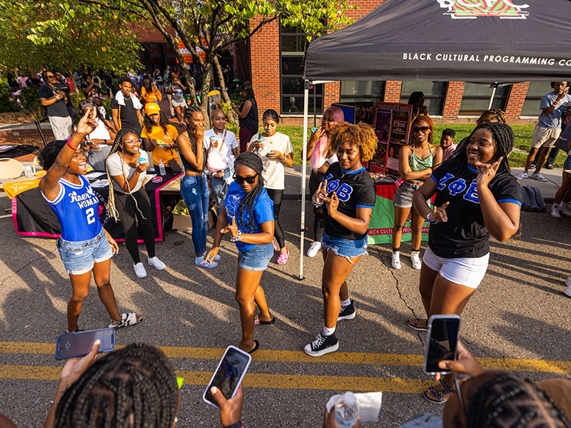 Students dance in the street outside the Frieson Black Cultural Center