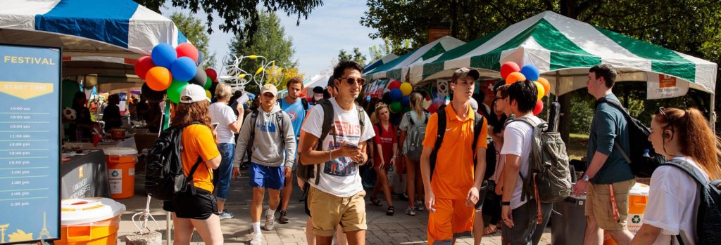 Students walk through a row of booths during the International Festival on Pedestrian Walkway.