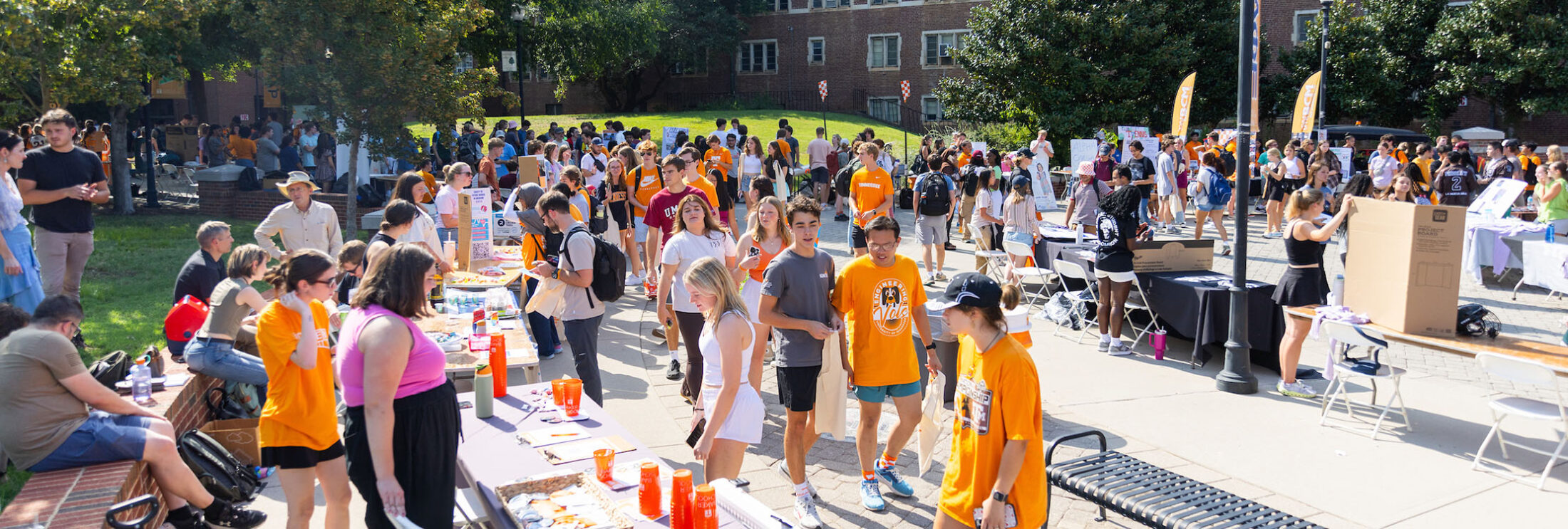 Students walking past club tables during the Student Engagement Fair.