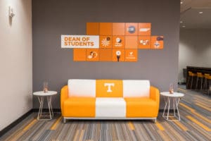 A couch with alternating orange and white blocks and the Power T logo