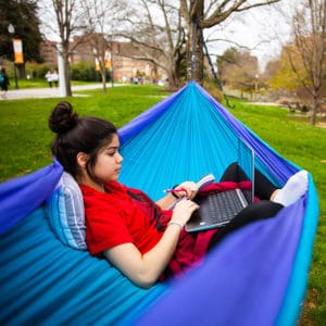 Student with a laptop in a hammock in Circle Park