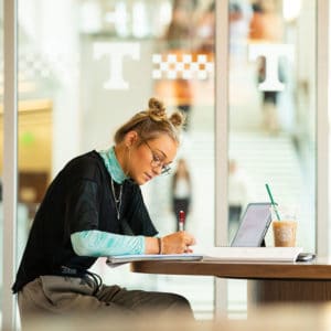 Student working at a table in the Student Union