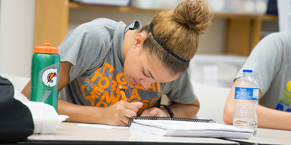 Female student taking notes during a workshop