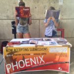 Students reading the Phoenix Literary Magazine