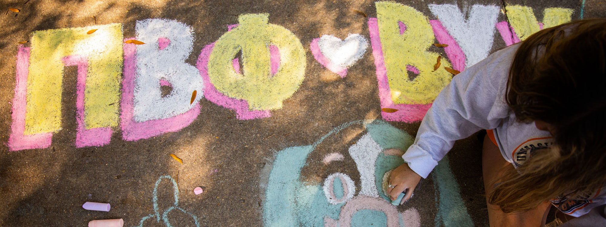 Students decorate Ped walkway with Smokey chalk art