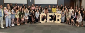 Members of CEB posing with light up CEB letters