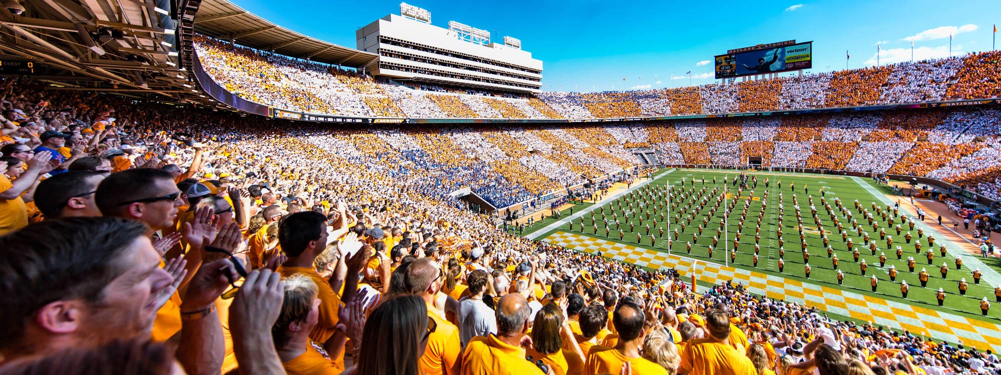 a large crowd attending a football game in Neyland Stadium