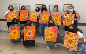 Student attending the Symbol of El Sol: Paint Night event