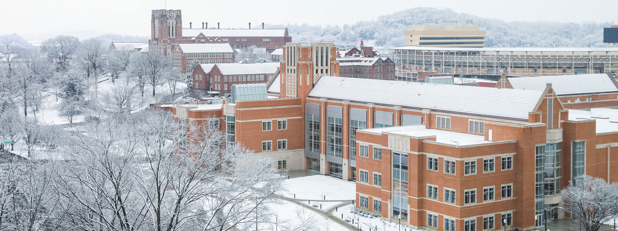 An overview of Ayres Hall and the new Student Union as snow covers campus