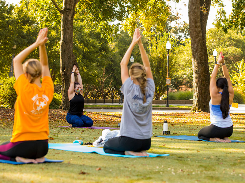 Students practice yoga in Circle Park