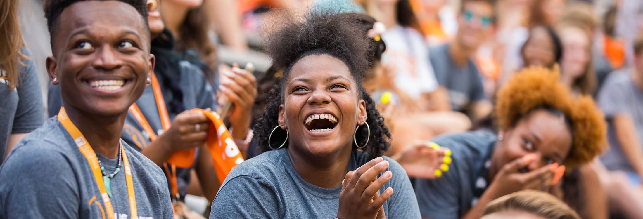 Students in a crowd smiling