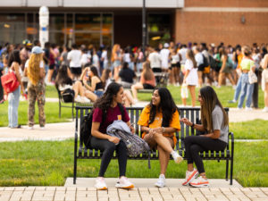 Students visit on a bench before Meet the Greeks at the Student Union Plaza on August 24, 2022.