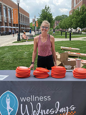 Emily Johnson poses with a Wellness Wednesday display