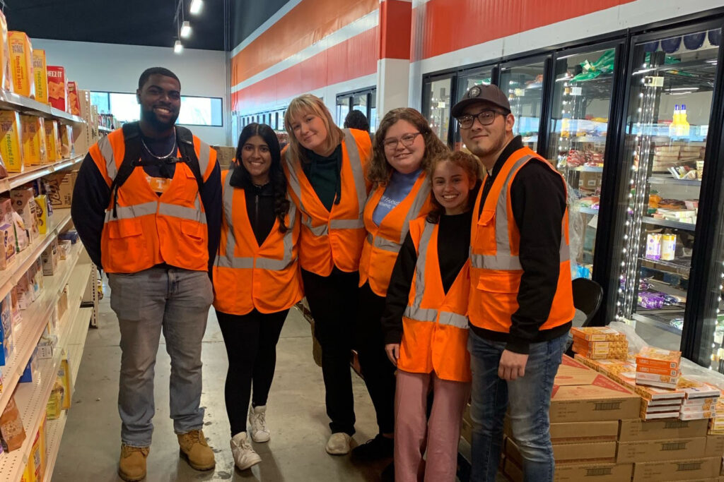 VOLbreaks participants pictured in orange visibility vests at a service project