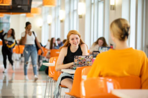 Students sitting at tables in the Student Union