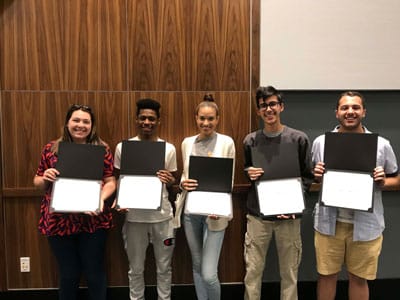 Picture of 5 individuals holding an open certificate