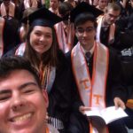 Selfie of 3 students at UT graduation ceremony. Students are in cap and gowns.