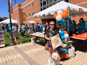 Kori Turney and her service dog participate in Vols Walk for Sexual Assault Awareness Month on a sunny day outside the Student Union.