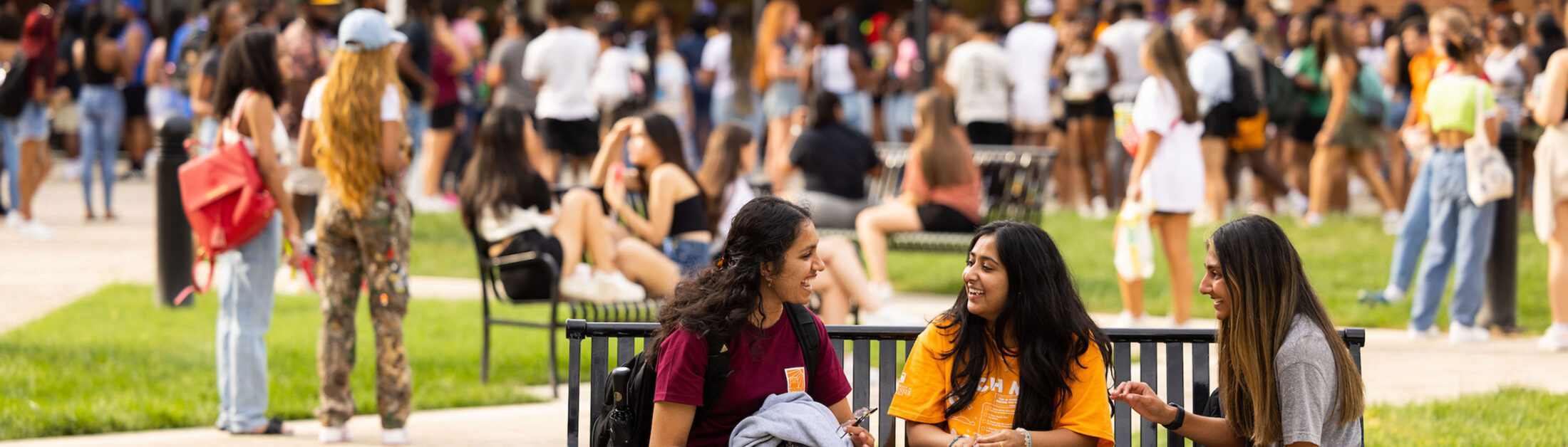 Students visit on a bench before Meet the Greeks at the Student Union Plaza on August 24, 2022